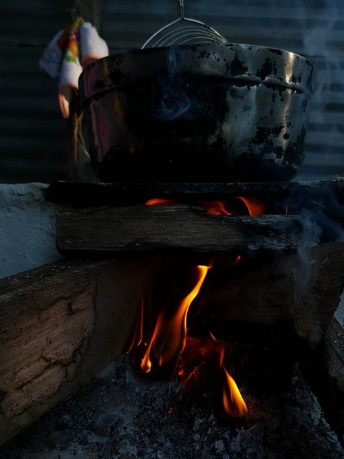 Free A cooking pot over an open wood fire, capturing the essence of outdoor cooking in a rustic setting. Stock Photo