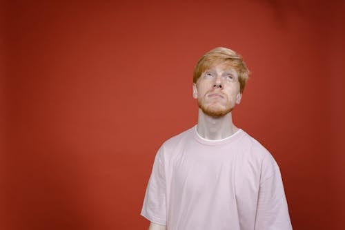 Man in Pink Crew Neck Shirt with Red Background