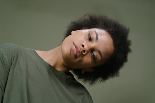 Woman in Green Crew Neck Shirt Looking at Camera