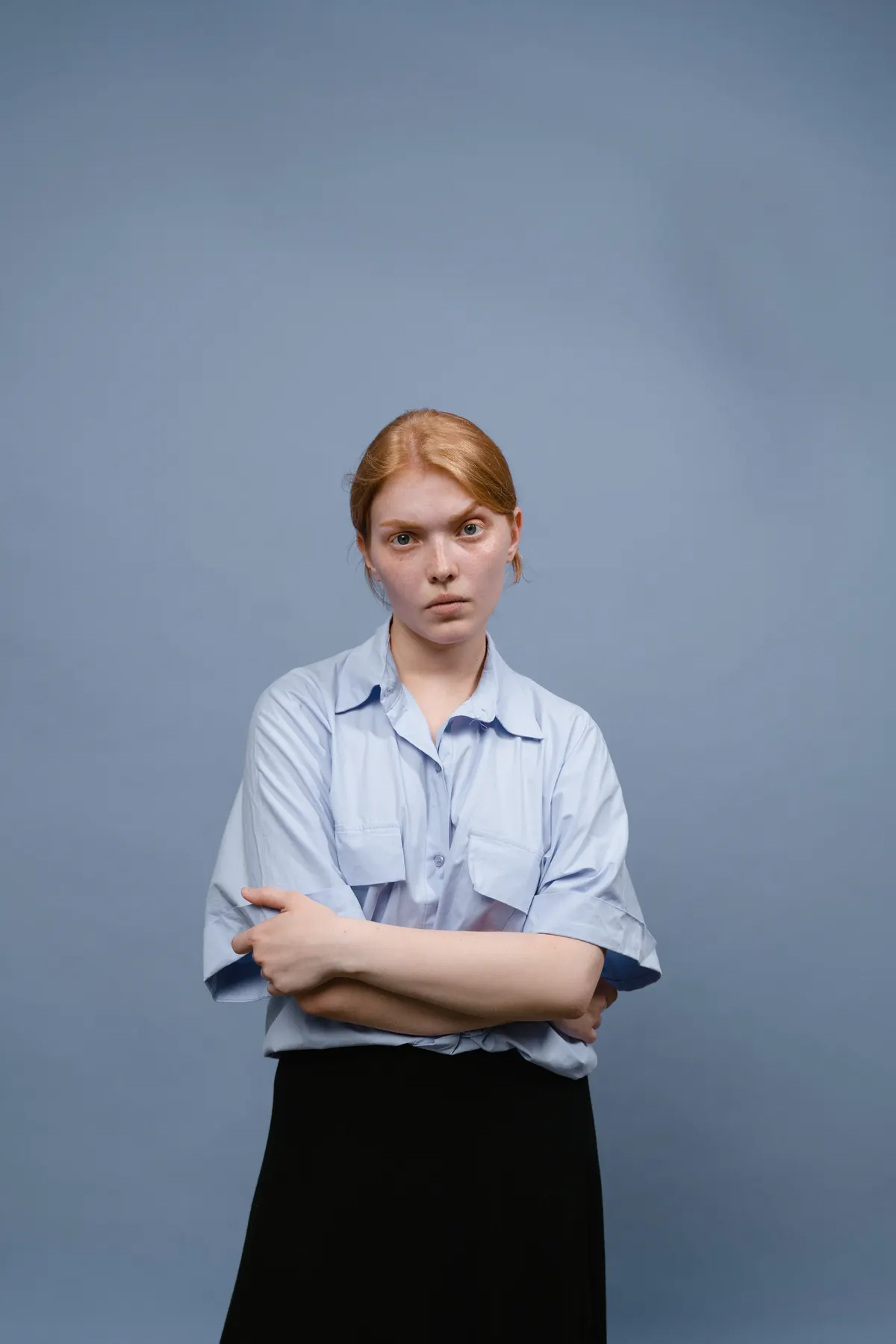 Businesswoman in blue shirt, arms crossed
