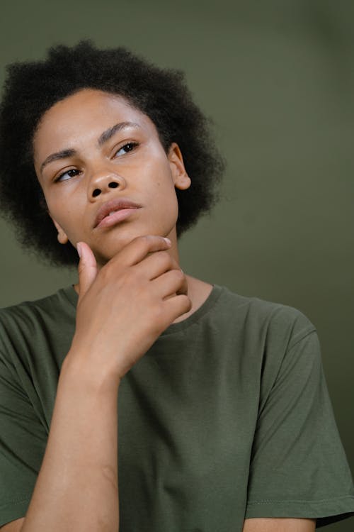 A Woman in Gray Shirt with Her Hand on Her Chin