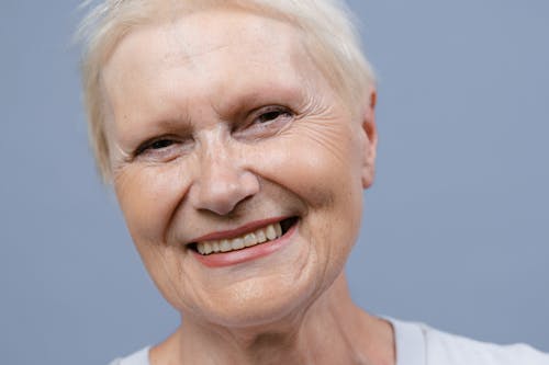 Close-Up Shot of an Elderly Woman Smiling 