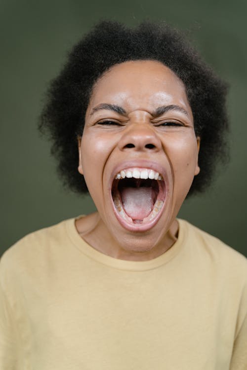 A Woman in Beige Shirt Screaming