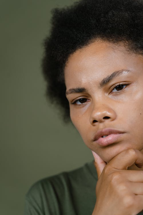 Close Up Photo of a Woman with Her Hand on Her Chin