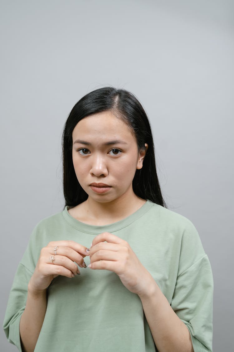 Shy Woman Wearing Green Shirt