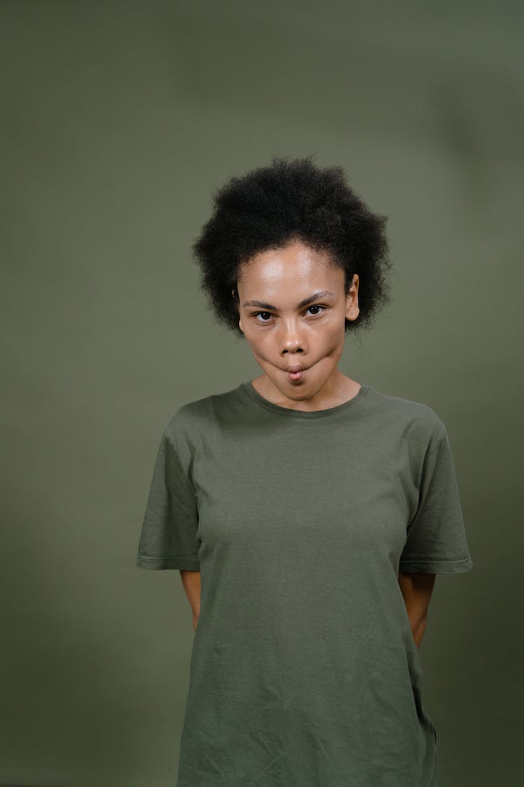 A Woman In Gray Shirt Looking With A Wacky Face