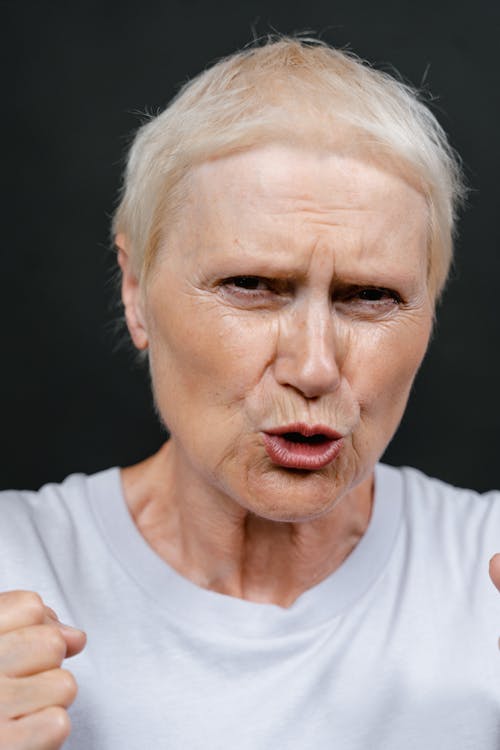 Close-Up Photo of a Senior Woman Looking Angry