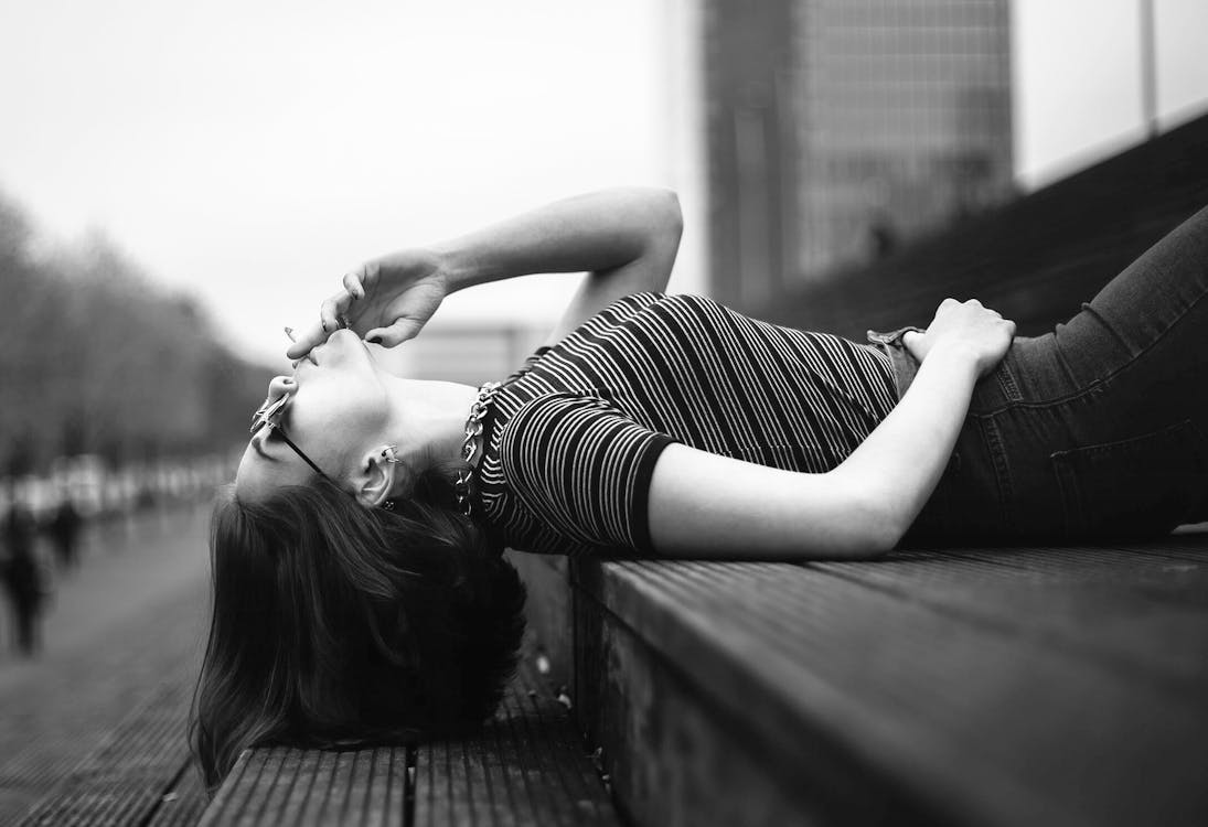 Free Woman Laying on Stairway Grayscale Photo Stock Photo