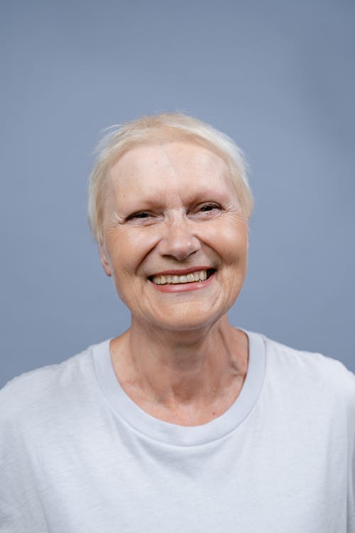 Smiling Elderly Woman in White T-Shirt