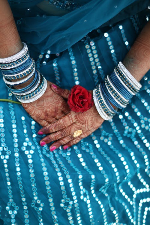 Free Woman's Hands with Henna Tattoo Holding Red Rose Stock Photo