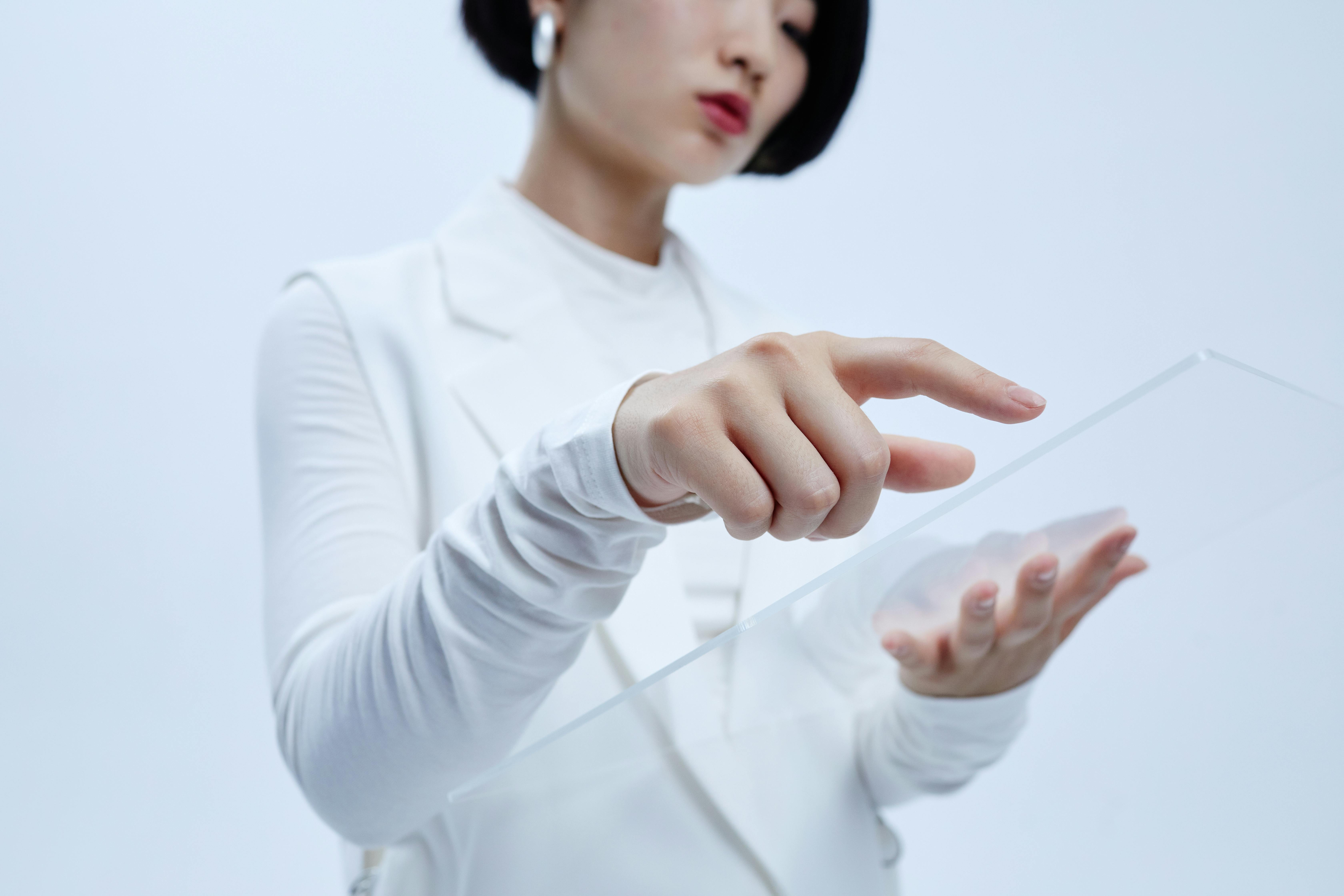 woman in a white outfit holding a transparent plate