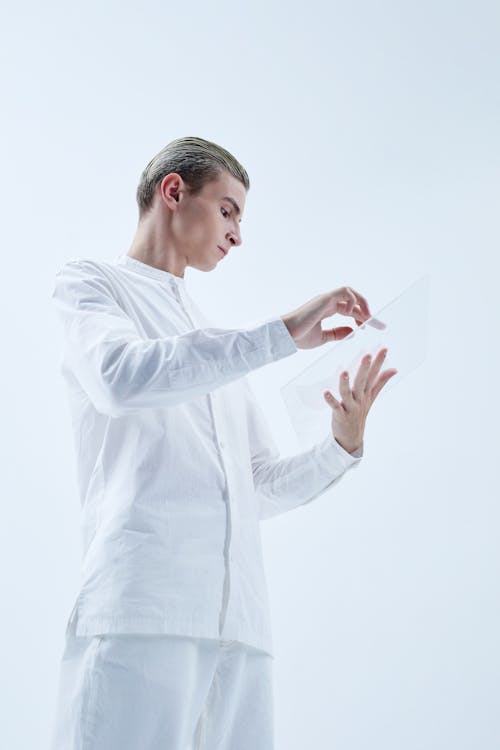 Man in White Long Sleeve Shirt Holding White Paper