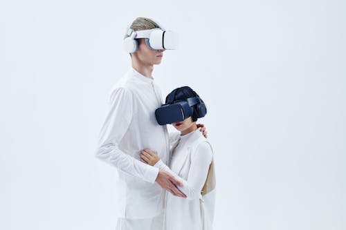 Man and Woman Standing Beside Each Other Wearing Oculus Quest