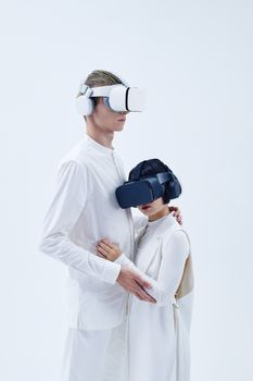 A diverse couple immersed in virtual reality with VR headsets and headphones against a minimalist white background.