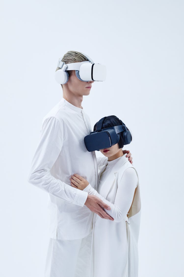 A Man And Woman Using A VR Goggles