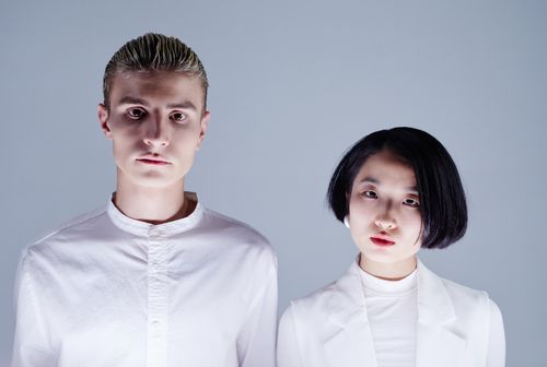 Free Close-up portrait of a man and woman in white clothing on a plain background. Stock Photo