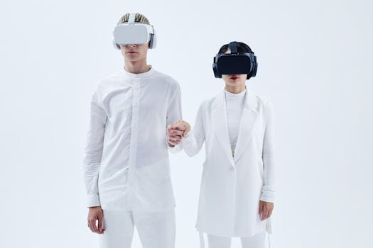 Two people in white attire wearing virtual reality headsets and holding hands, embracing technology.