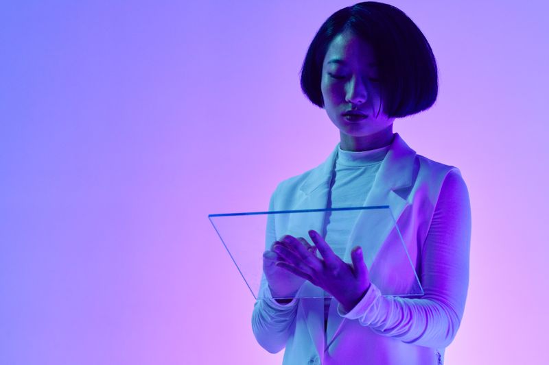 Woman interacting with transparent digital screen