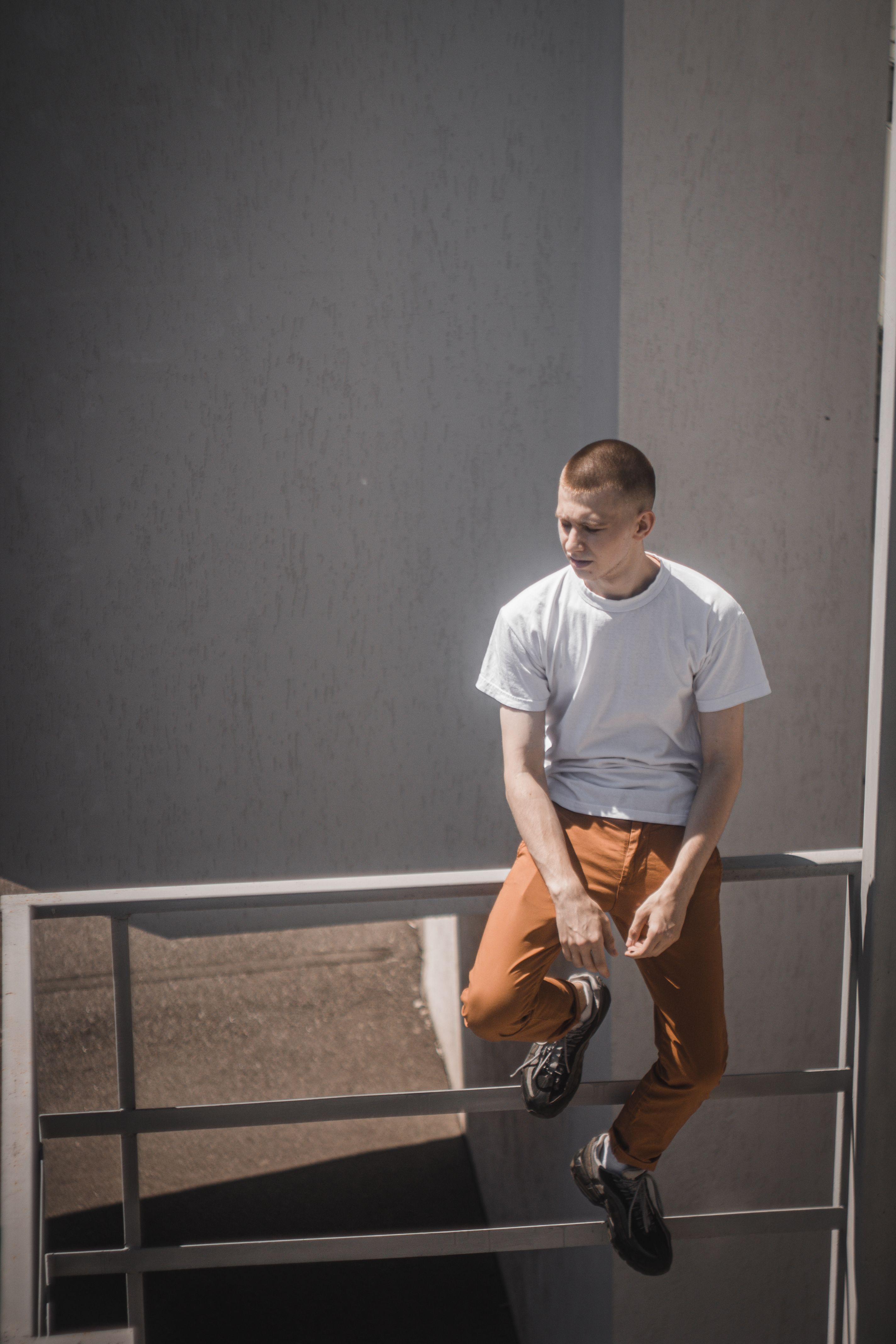 Sitting Railing Person Sitting on Railings in Front of a Waterfalls · Free Stock Photo