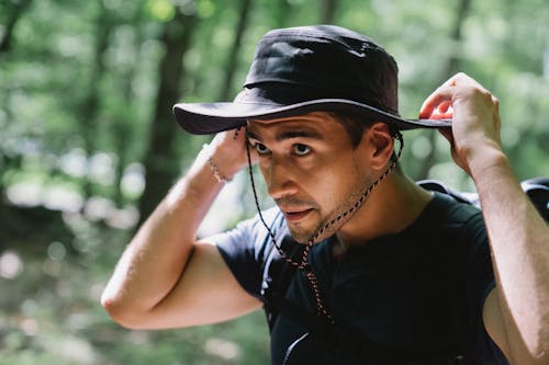 Free Man Touching Hat on the Head Stock Photo