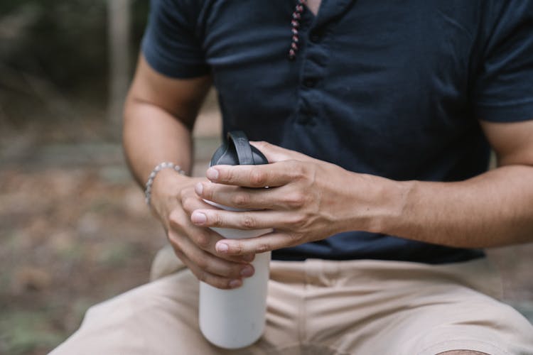 Close-Up Shot Of A Person Holding A Water Bottle