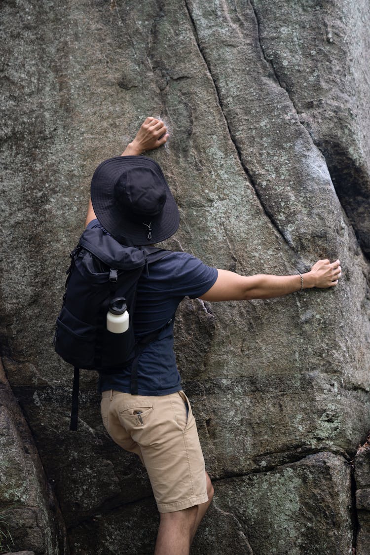 A Man Climbing A Rock