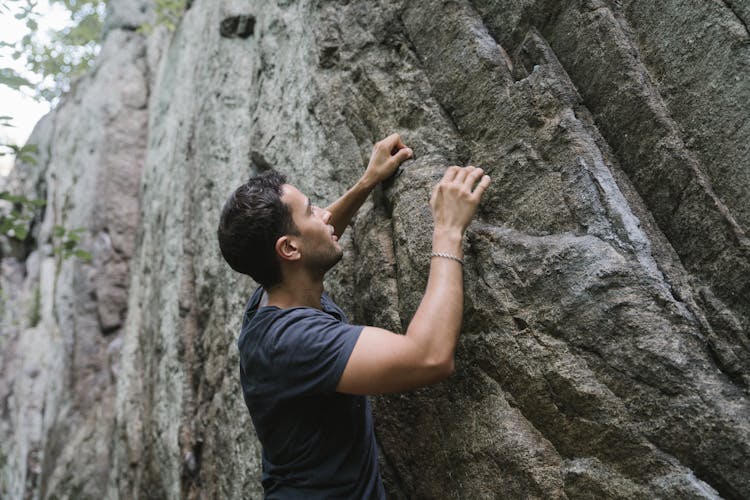 A Man Climbing A Rock