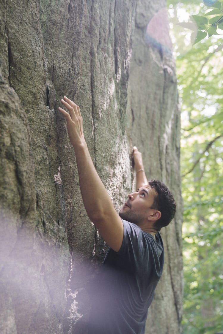 A Man Climbing A Rock