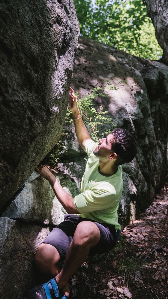 Climber reaching for a hold on an outdoor boulder, photo by Katya Wolf on Pexels