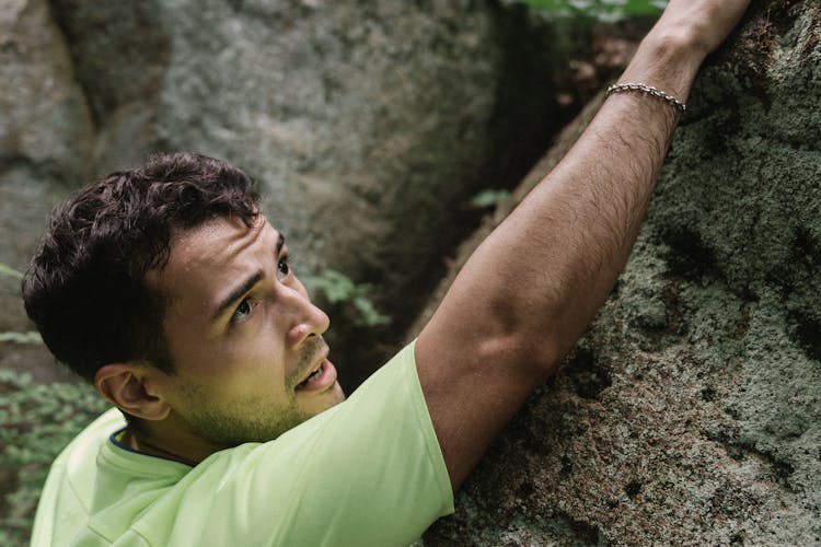 Man Climbing On A Rock