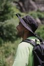 Man in Green Shirt Wearing Black Hat