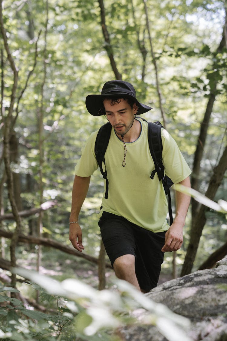 A Man In Green Shirt Hiking