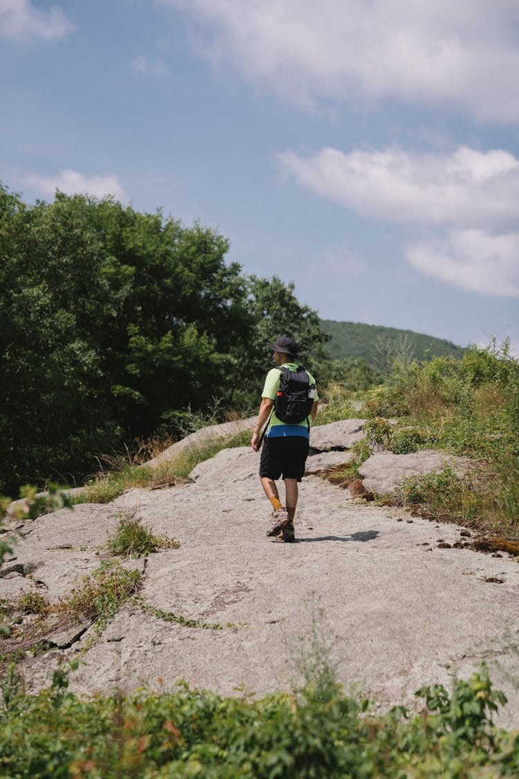 A Man In Green Shirt Hiking