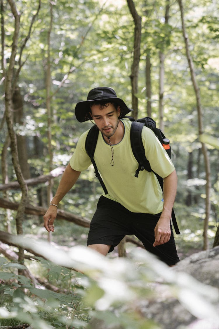 A Man In Green Shirt Hiking