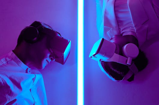 Two adults wearing VR headsets under neon lights, exploring virtual worlds in a studio setting.