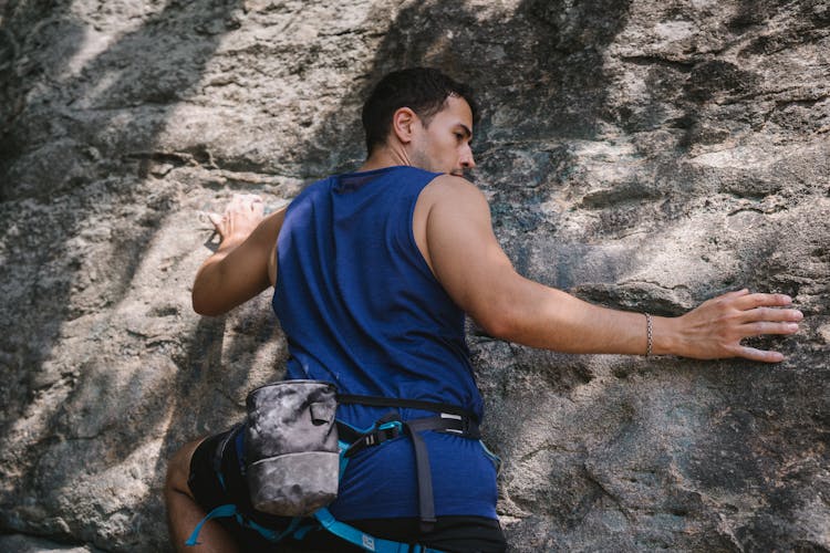 A Man Climbing A Rock