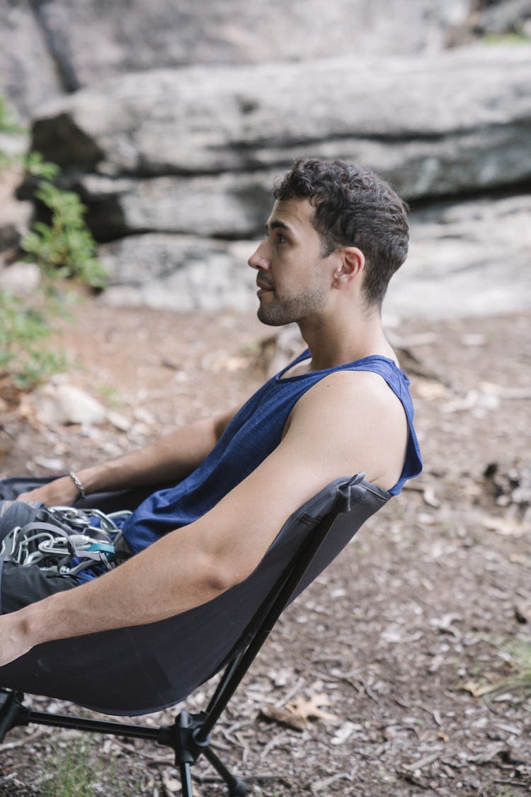 Side View Of A Man Sitting On A Chair 