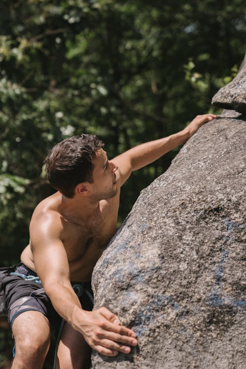 Shirtless Man Rock Climbing
