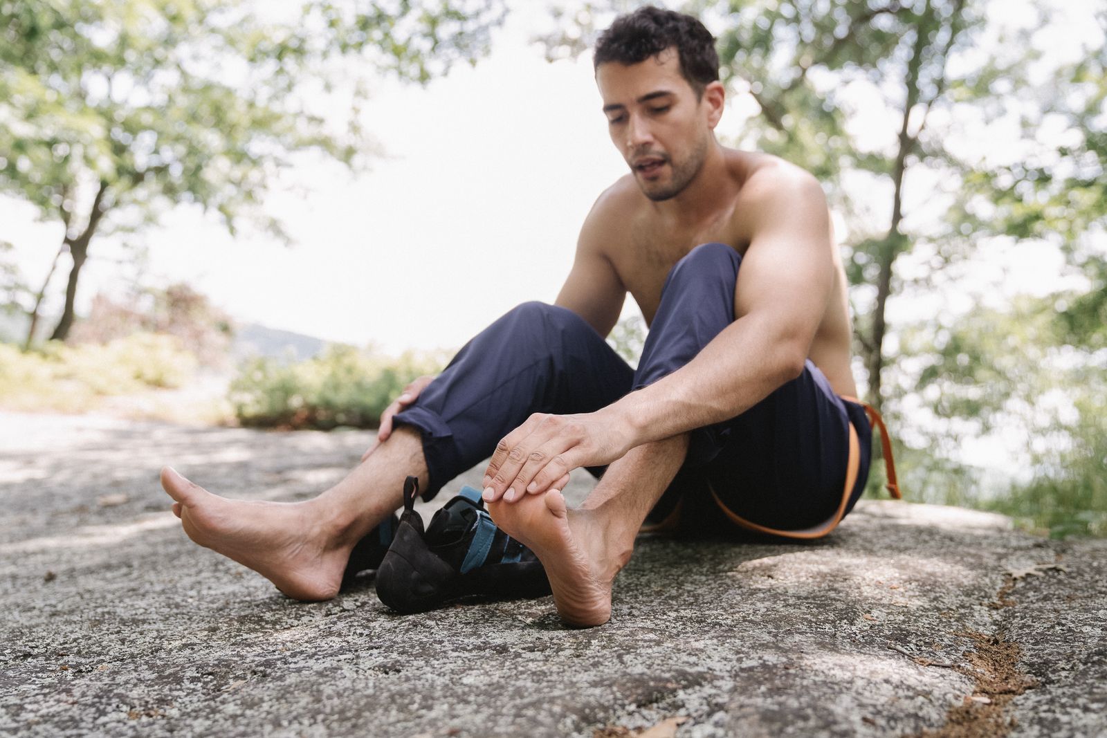 Person tying walking shoes before choosing a foot drop brace size