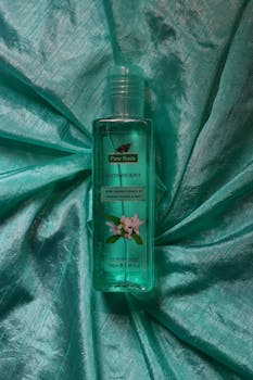 Pure Roots astringent bottle placed on a turquoise silk fabric, ideal for beauty and skincare theme.
