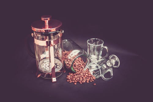 Photograhy of Brown Beans, Clear Glass Mug, and Brass Coffee Grinder