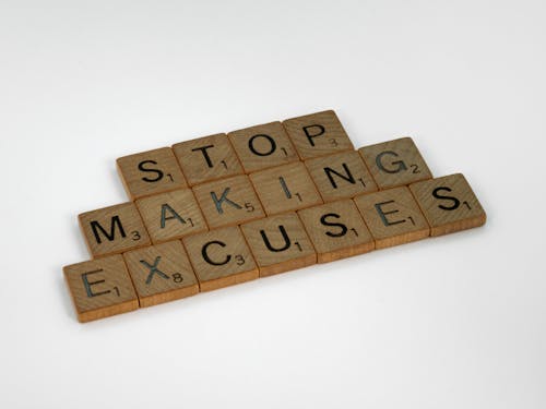 Close-Up Shot of Scrabble Tiles on a White Surface