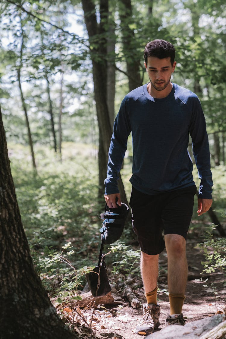 A Man Wearing A Long Sleeved Shirt Hiking