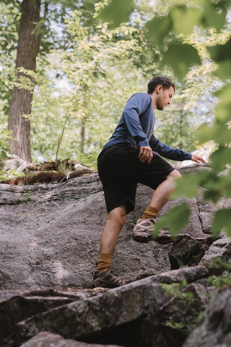 Man Climbing A Rocky Mountain