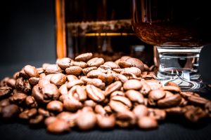 Roasted coffee beans in front of a dark glass — Georgi Petrov on Pexels