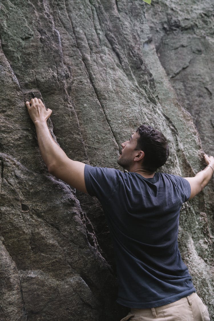 A Man Climbing A Rock