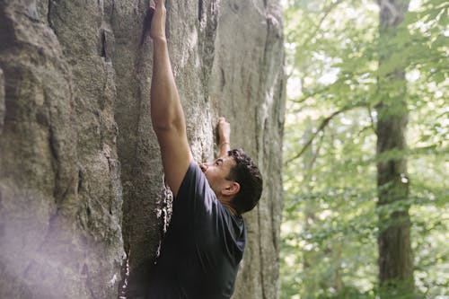 Man in a Shirt Rock Climbing