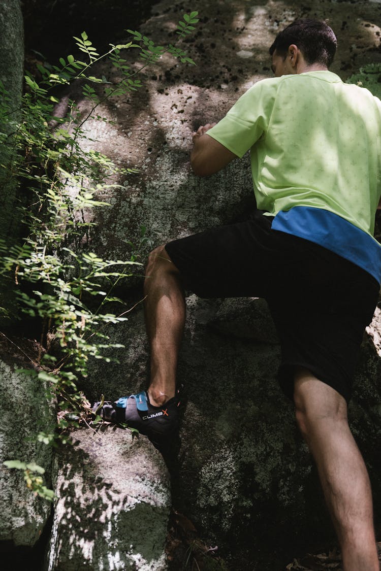 A Man Climbing A Rock