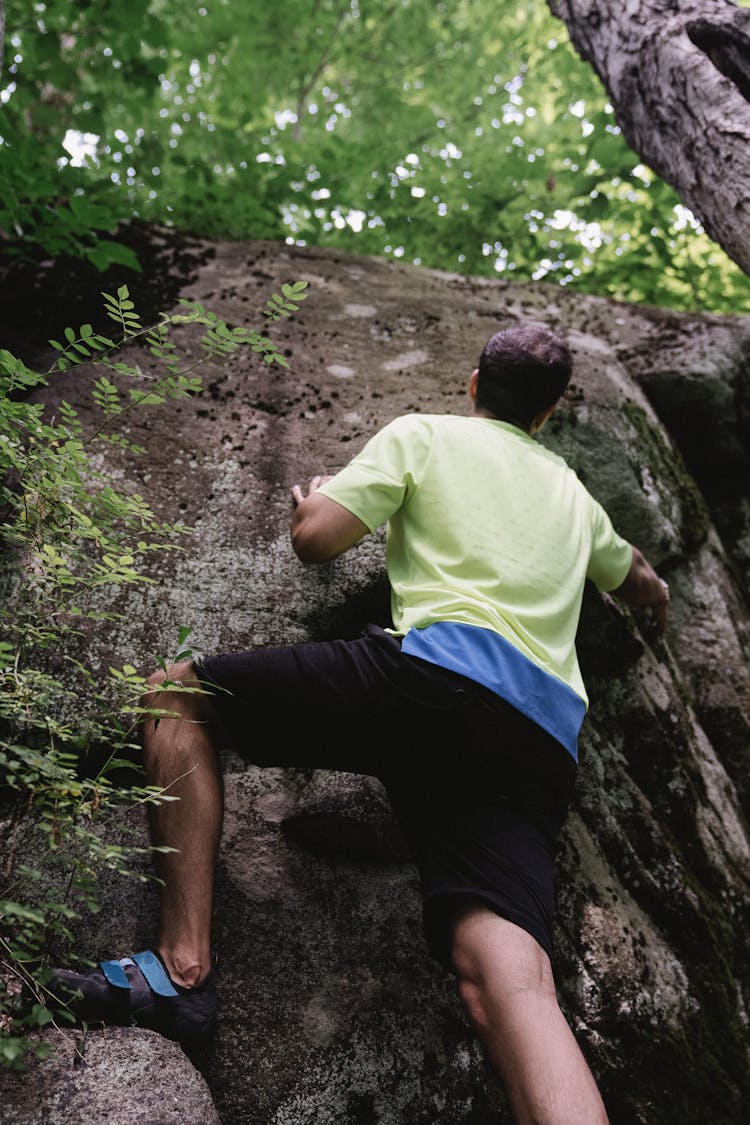 A Man Climbing A Rock