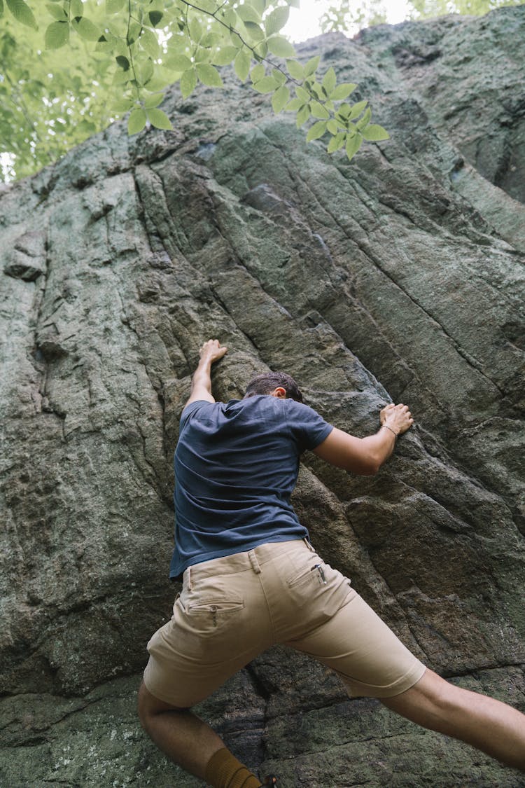 A Man Climbing A Rock